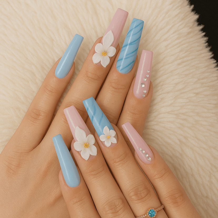 Stylish long acrylic nails in blue and pink with floral design and rhinestones.